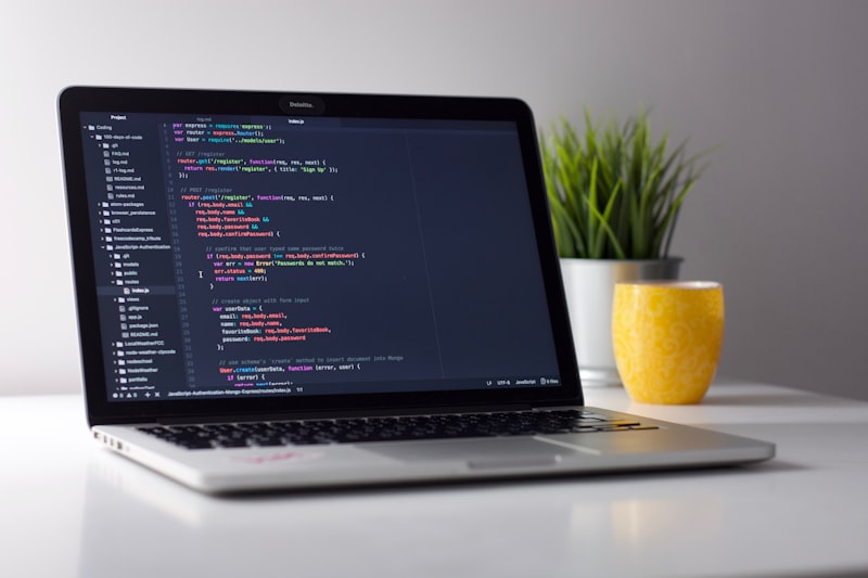 Developer writing code on a laptop